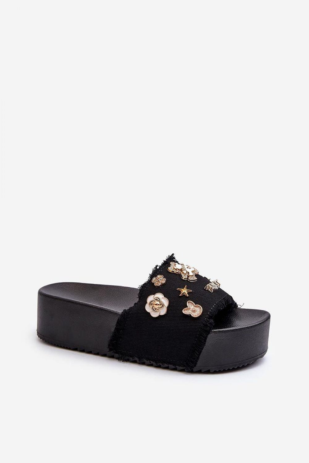 Toriva Foam Platform Badge Slides with decorative badges, sculptural foam upper, and 4.5 cm platform height, in black.