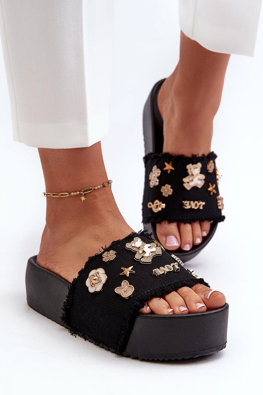 Toriva Foam Platform Badge Slides with whimsical badges and sculptural form, offering casual height and comfort in black foam.