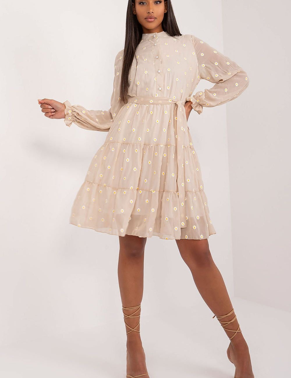 Model wearing Florielle Cotton Bloom Dress with floral pattern, flared cut, long puffed sleeves, and tie belt, exuding vintage charm.