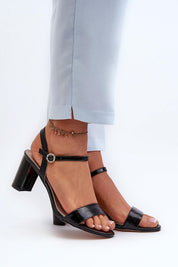 Woman wearing Zarellia Metallic Strap Post Heel Sandals with decorative buckle and eco leather upper, showcasing elegance and comfort.