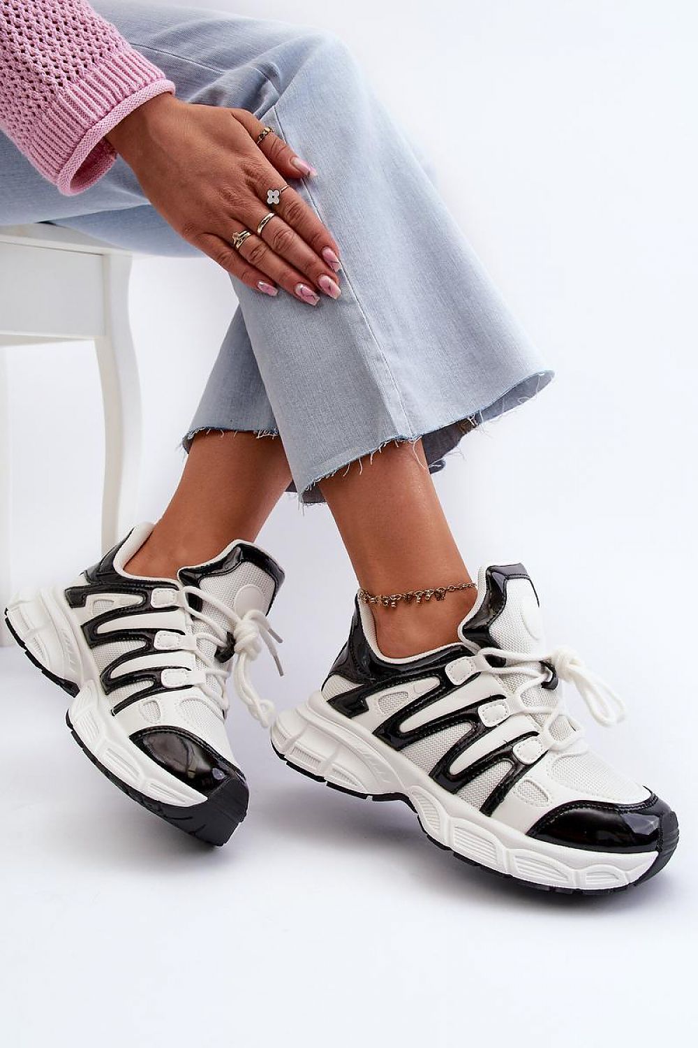 Stylish Astaria thick-soled street sneakers with black and white design, offering durability and urban edge for everyday wear.