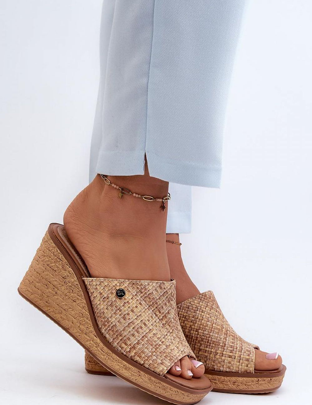 Woman wearing Ardeva Braided Wedge Flip-Flops, featuring a synthetic braided-look platform and natural leather footbed.