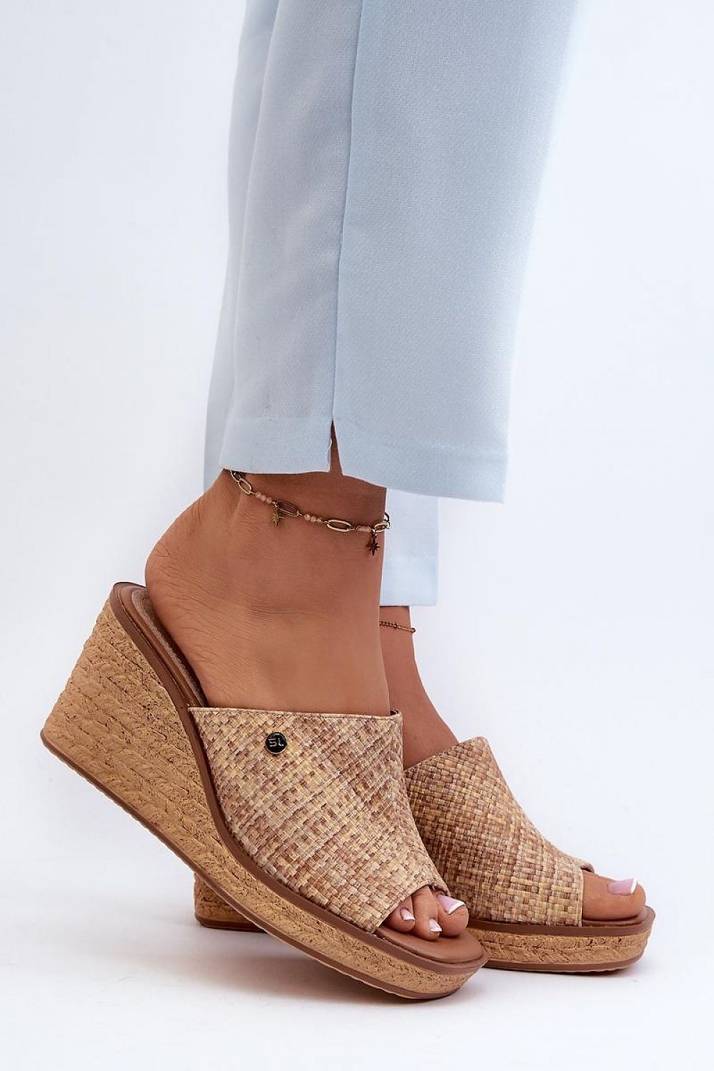 Woman wearing Ardeva Braided Wedge Flip-Flops, featuring a synthetic braided-look platform and natural leather footbed.