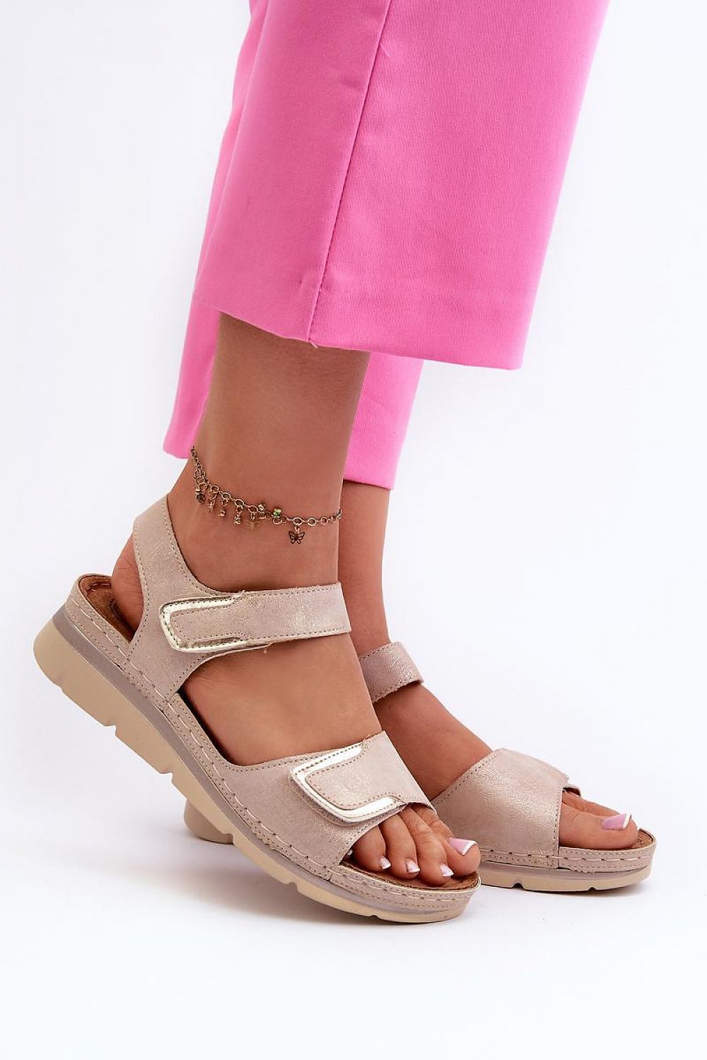 Velmera Lightweight Strap Sandals in beige with Velcro fastening, worn by a person in pink pants, showing comfort and style.