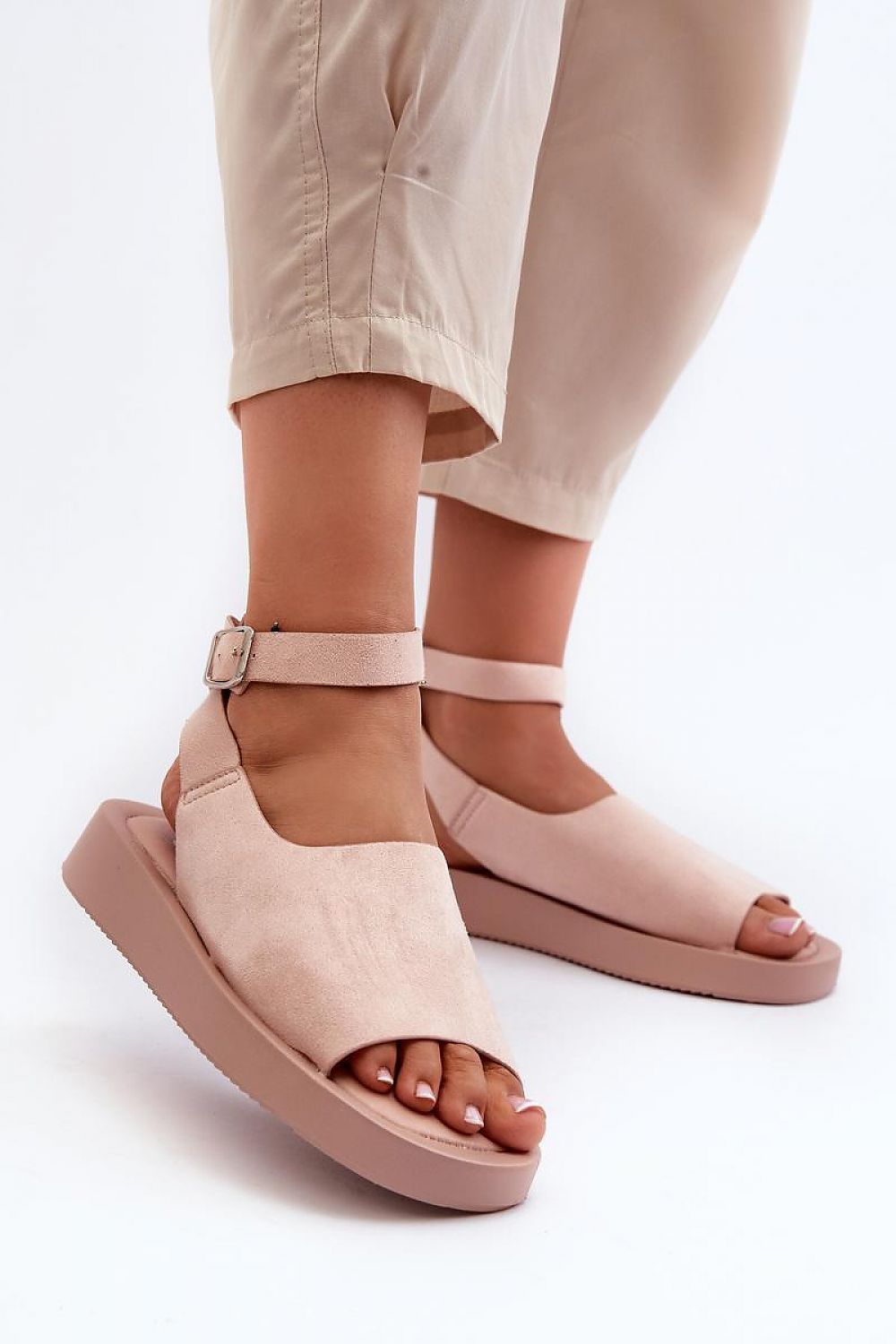 Nirella suede platform sandals with eco-suede upper, eco leather insole, and adjustable ankle strap, highlighting its chic silhouette.