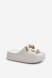 Floriva thick-sole foam flip-flops with decorative accents, lightweight platform design for comfort and style, ideal for summer wear.