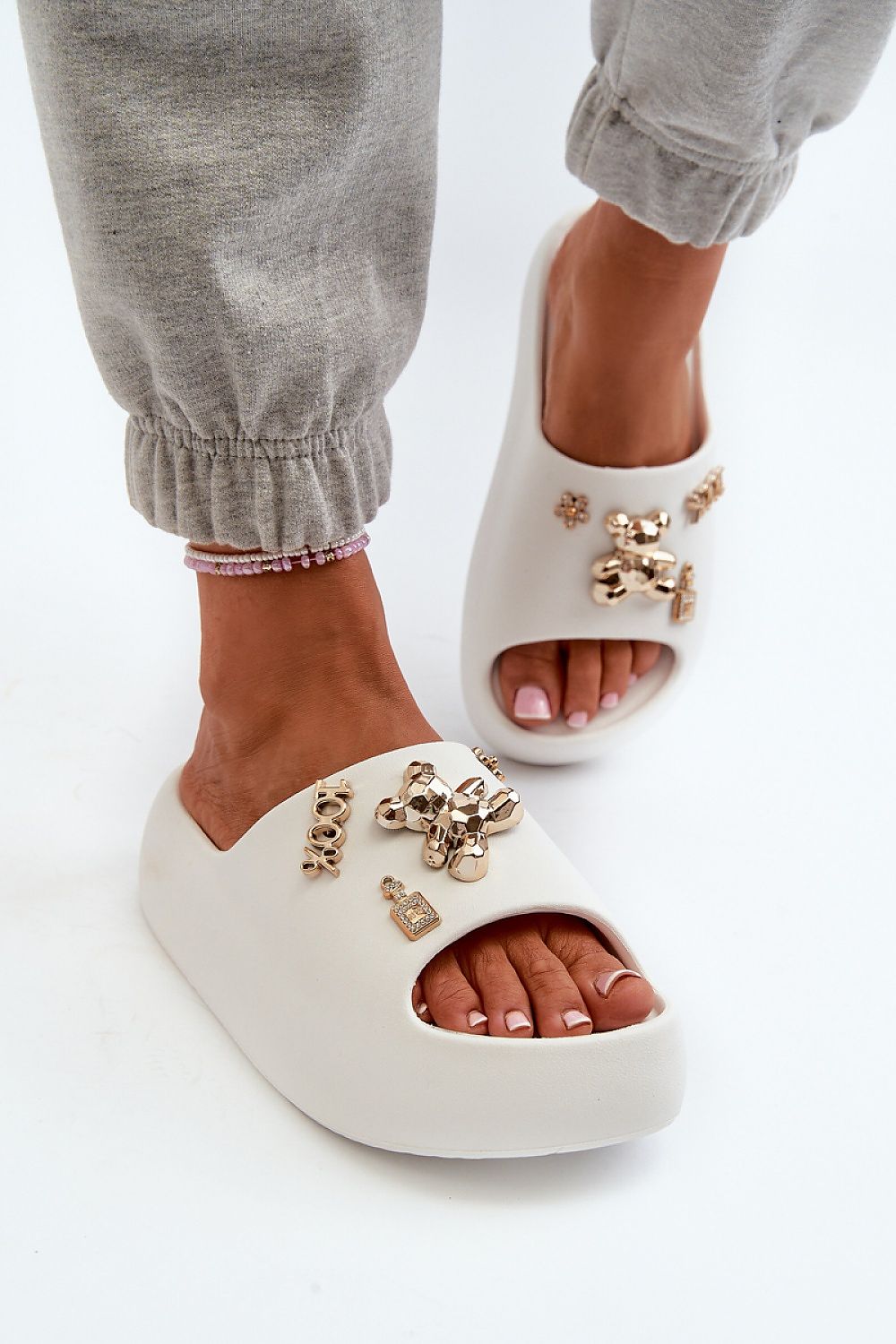 Floriva Thick-Sole Foam Flip-Flops with decorative accents, featuring a 5.5 cm platform, worn with casual grey pants for a stylish look.