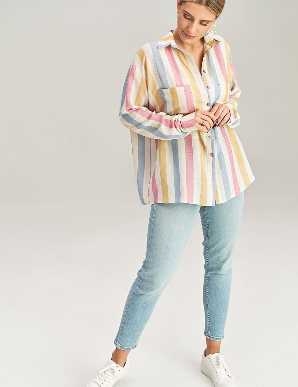 Model wearing Maelora Asymmetrical Pocket Shirt with colorful stripes, paired with light jeans and white sneakers.