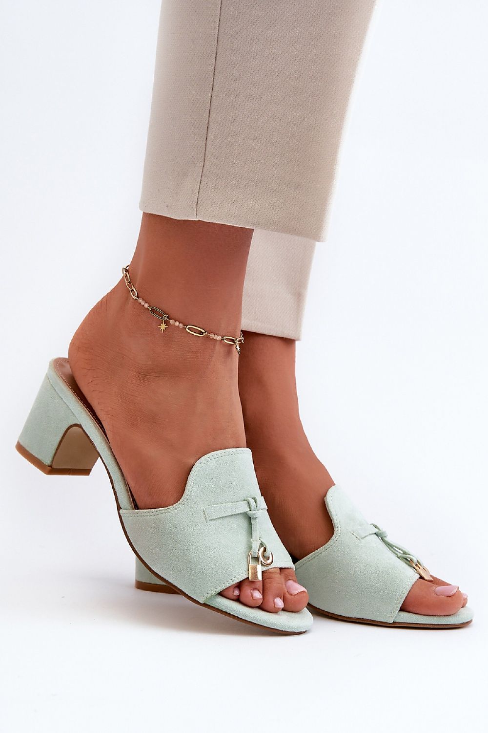 Mint green Solvera heeled suede flip-flops with 5.5 cm heel on foot, showcasing a chic, minimalist summer style for casual or dressy outfits.