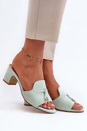 Mint green Solvera heeled suede flip-flops with 5.5 cm heel on foot, showcasing a chic, minimalist summer style for casual or dressy outfits.