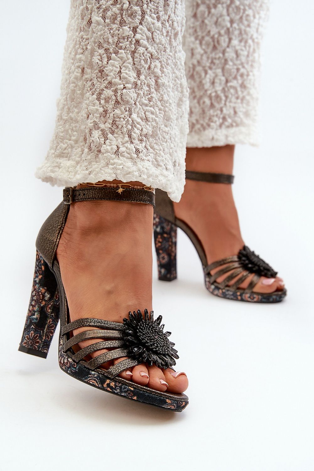 Lysoria Sculpted Leather Sandals featuring high heels, ankle straps, and floral embellishments, elegant and sophisticated footwear design.