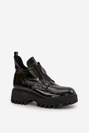 Virelsa Cresthold Leather Form ankle boots with chunky heel, grooved platform, and sculptural embellishment, made of glossy black leather.