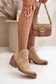 Nivarelle Cutflare suede ankle boots with sculptural cutouts and mid-height heel, perfect for stylish transitional dressing.