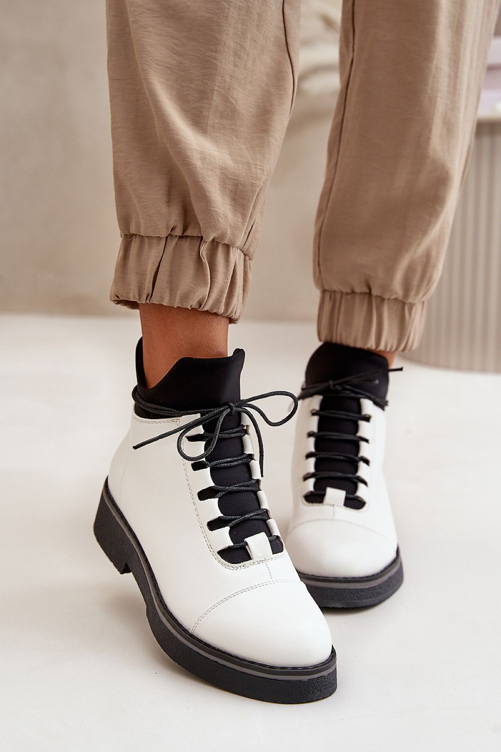 Woman wearing Arvelune Warmfold ankle boots in eco-leather with warm lining and flat heel.