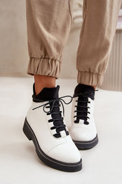 Woman wearing Arvelune Warmfold ankle boots in eco-leather with warm lining and flat heel.
