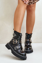 Model wearing black Tirelle Buckled Platform Ankle Boots with eco leather, buckles, and flat heel, paired with leopard print skirt.