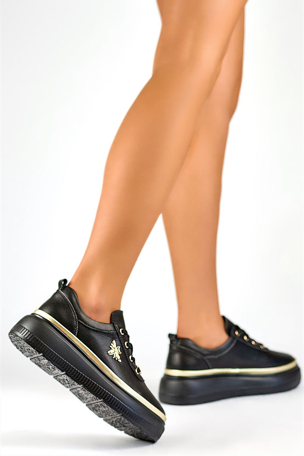 Black Valmerra Classic Platform Sneakers with gold accents, featuring a sculpted 5 cm platform and premium leather, shown in profile view.