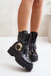 Stylish Bravora leather platform boots with gold buckle, lace-up front, and side zipper, perfect for bold fashion and comfort.