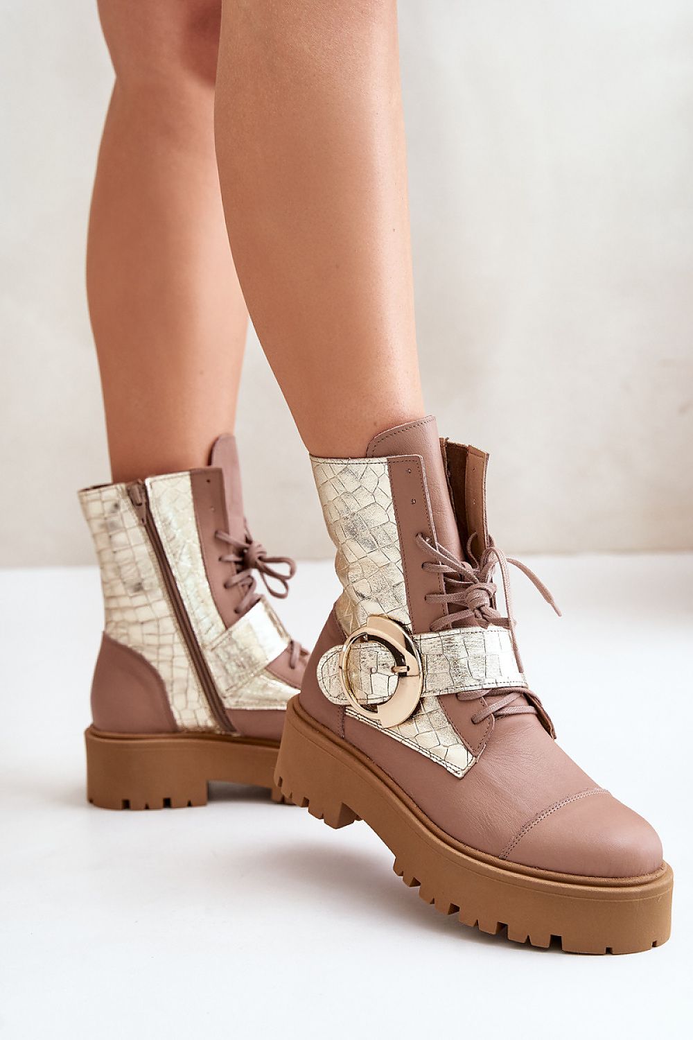 Bravora leather buckled platform boots with large buckle detail, side zipper, and lace-up design for bold style and comfort.