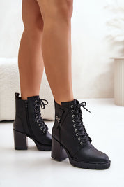 Black Noctera Luxe Zip-Up Heeled Boots with block heel, eco leather finish, lacing, side zip, and gold-accented strap for winter.