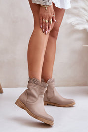 Valdera suede ankle boots with cutout detail and flat heel, showcasing rounded toes and side zipper for easy wear.