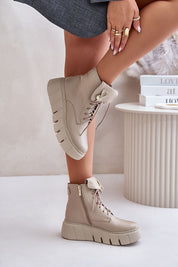 Woman wearing Kaelith Leather Platform Boots with side zipper and front lacing, featuring a safety pin accent and platform sole.