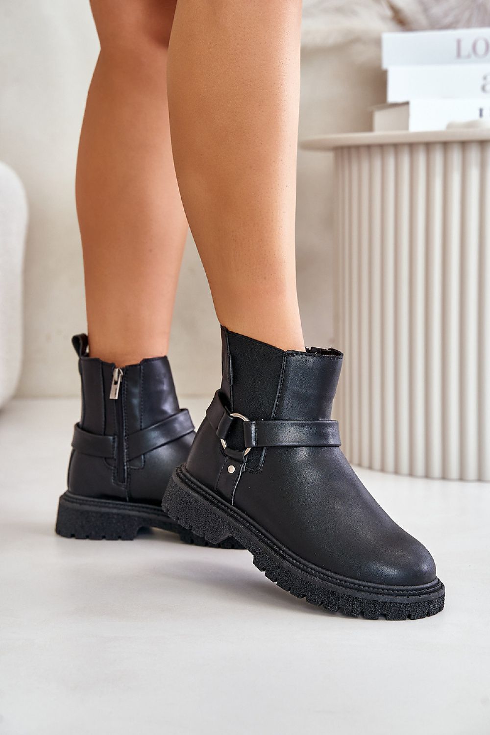 Black eco leather jodhpur boots with triple-stripe design, rounded toe, and side zipper for easy on-off. Perfect for colder seasons.