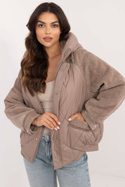 Velmora Quilted Hooded Jacket with corduroy sleeves, worn by model. Perfect for cool autumn and winter days, blending style and comfort.