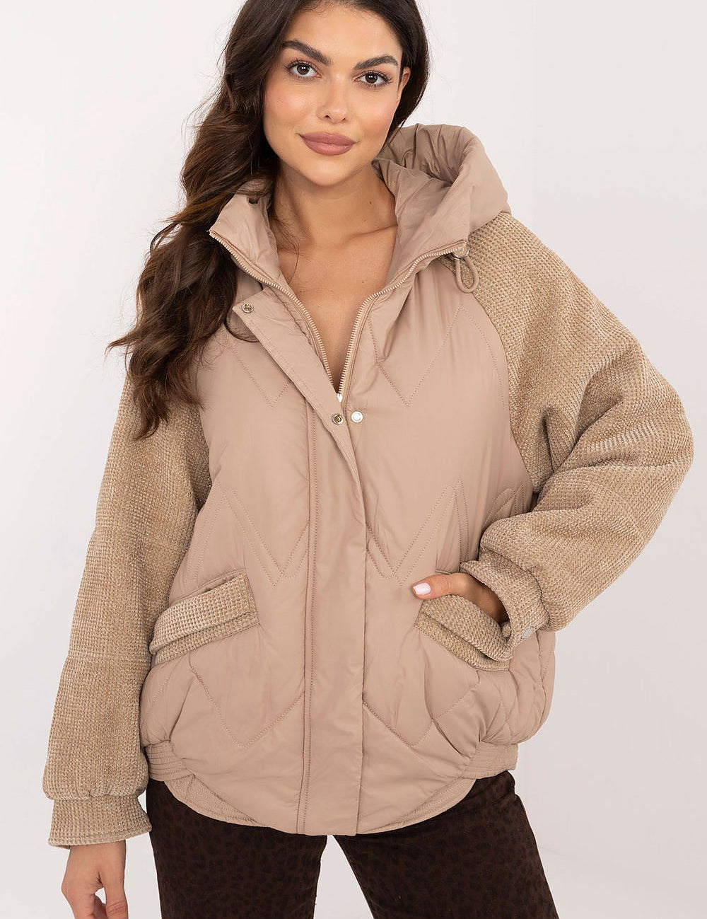 Woman wearing Velmora Quilted Hooded Jacket with corduroy sleeves and zip closure, ideal for autumn and winter urban style.