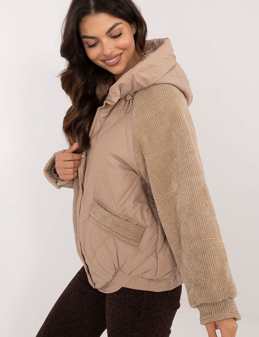 Woman wearing Velmora Quilted Hooded Jacket with corduroy sleeves, showcasing its urban style and lightweight comfort for autumn and winter.