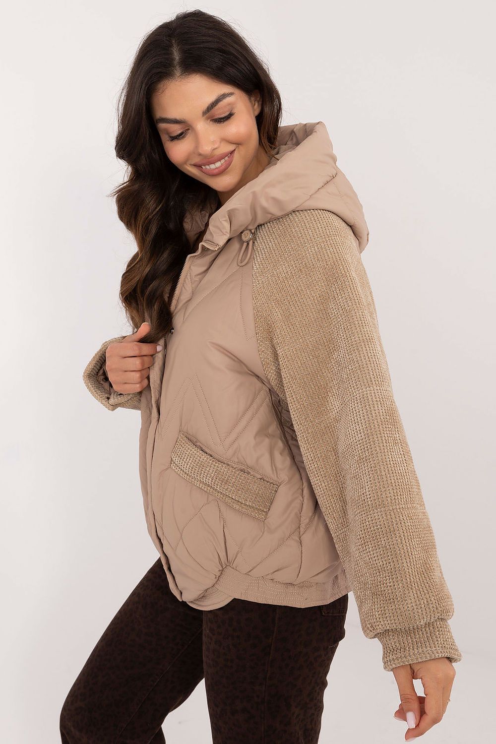 Woman wearing Velmora Quilted Hooded Jacket with corduroy sleeves, showcasing its urban style and lightweight comfort for autumn and winter.