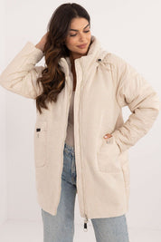 Woman wearing Cordivelle Quilted Hooded Jacket with corduroy front and quilted sections, perfect for autumn and winter.