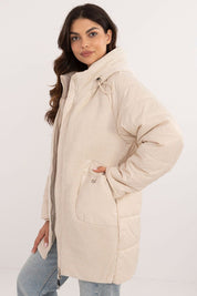Woman wearing Cordivelle Quilted Hooded Jacket with corduroy front panel, quilted sections, and zip closure for warmth and style.