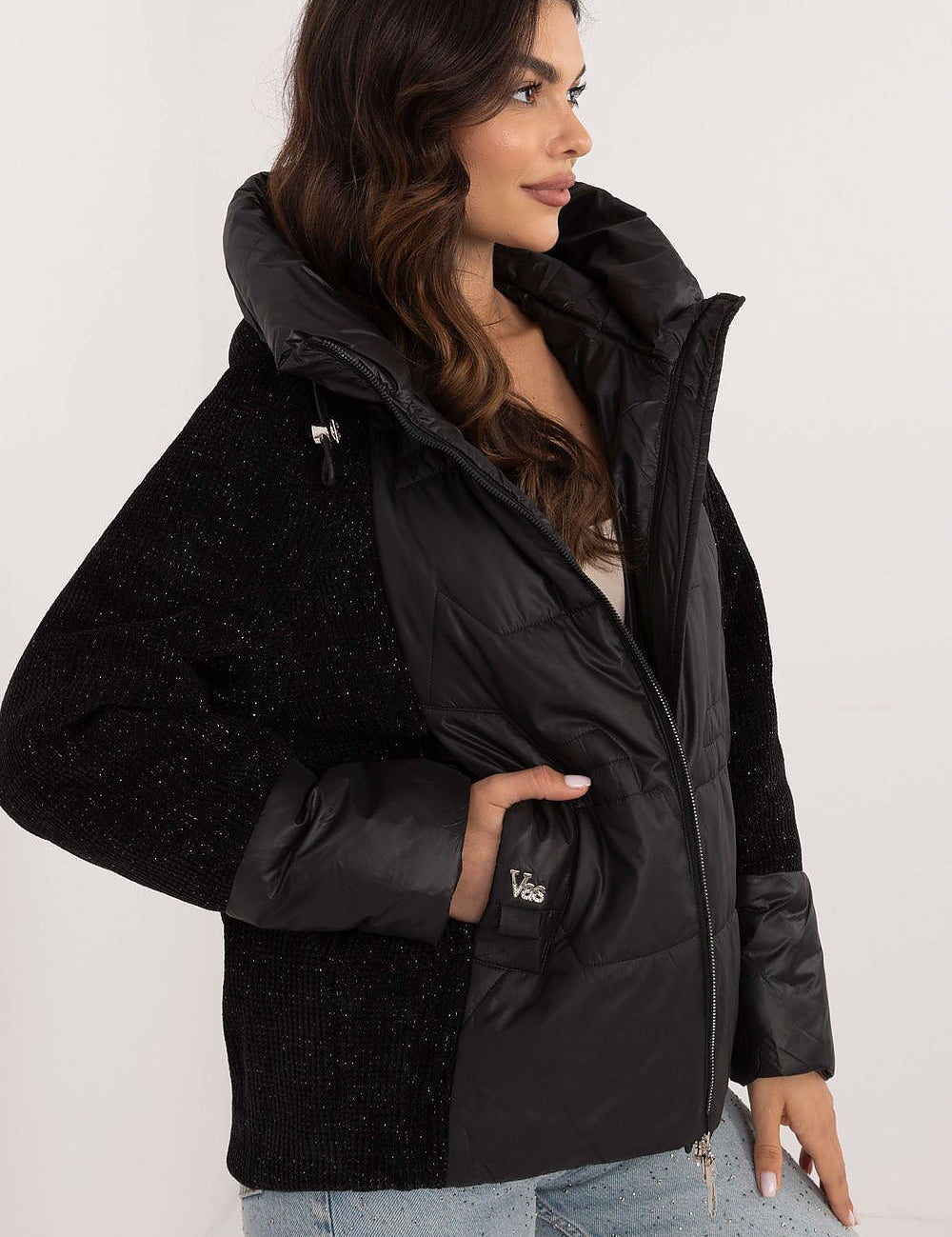 Woman wearing Velmorra Hooded Quilted Jacket with fitted hood and quilt pattern, showcasing sleek modern design and stylish functionality.