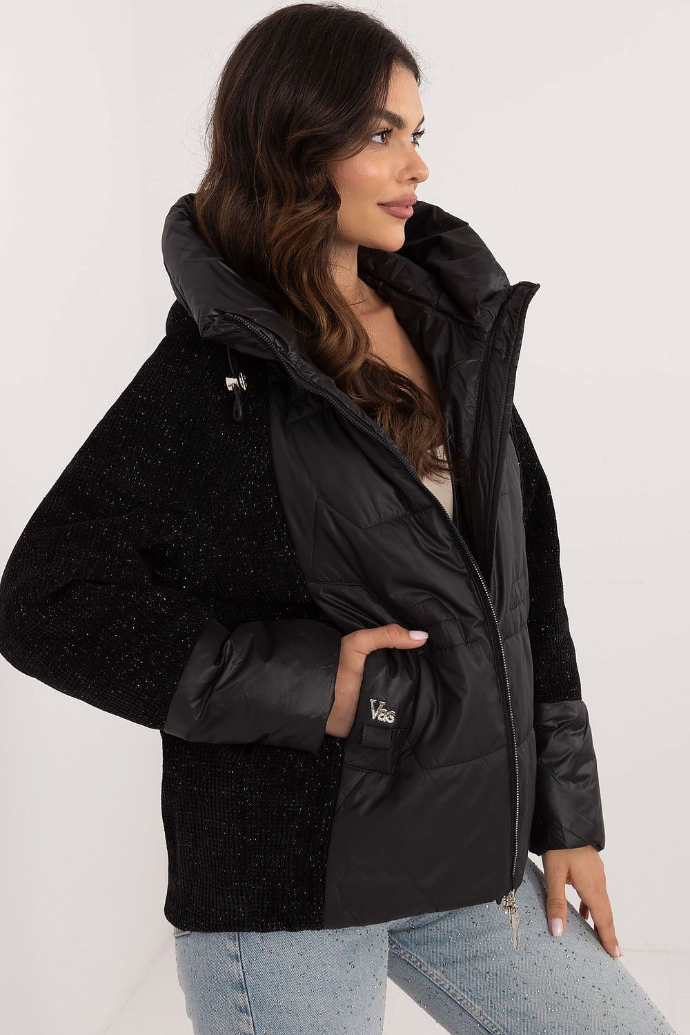Woman wearing Velmorra Hooded Quilted Jacket with fitted hood and quilt pattern, showcasing sleek modern design and stylish functionality.