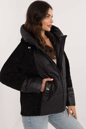 Woman wearing Velmorra Hooded Quilted Jacket with fitted hood and quilt pattern, showcasing sleek modern design and stylish functionality.