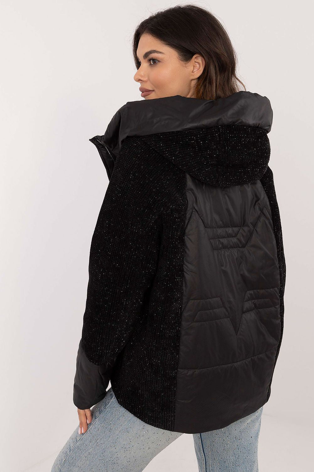 Woman wearing Velmorra Hooded Quilted Jacket in black, showing modern design and texture from back view.