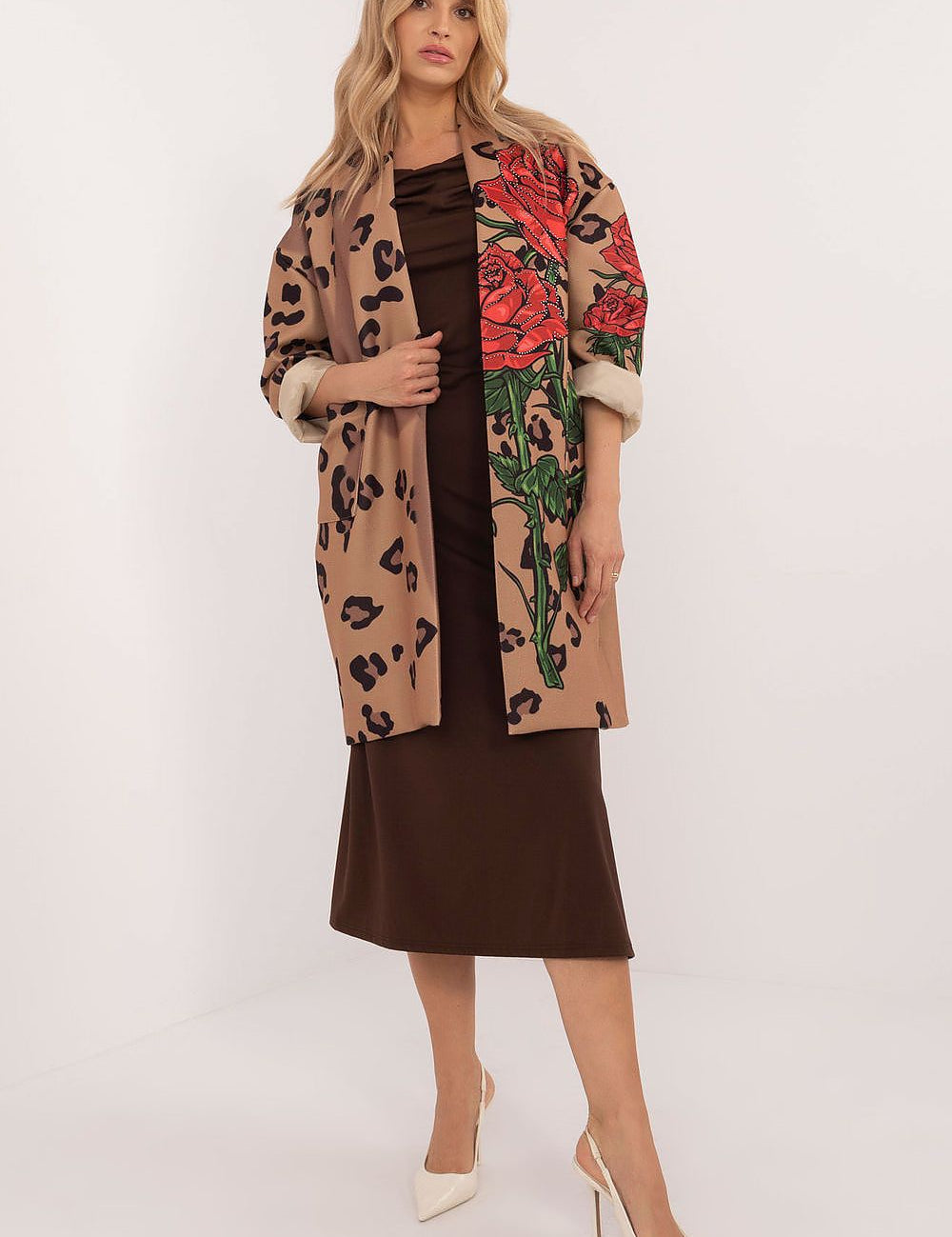 Woman wearing Florénne Rhinestone Rose Coat, showcasing a brown dress beneath, open-front design with rose print and rhinestone accents