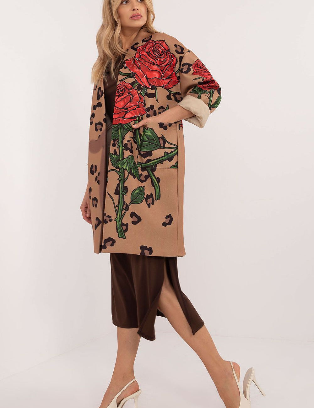 Florénne Rhinestone Rose Coat with red floral print and rhinestone accents, ideal for autumn layering; model wearing elegant apparel.