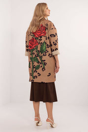 Woman wearing Florénne Rhinestone Rose Coat with stemmed rose print and rhinestone detail, perfect for transitional seasons.