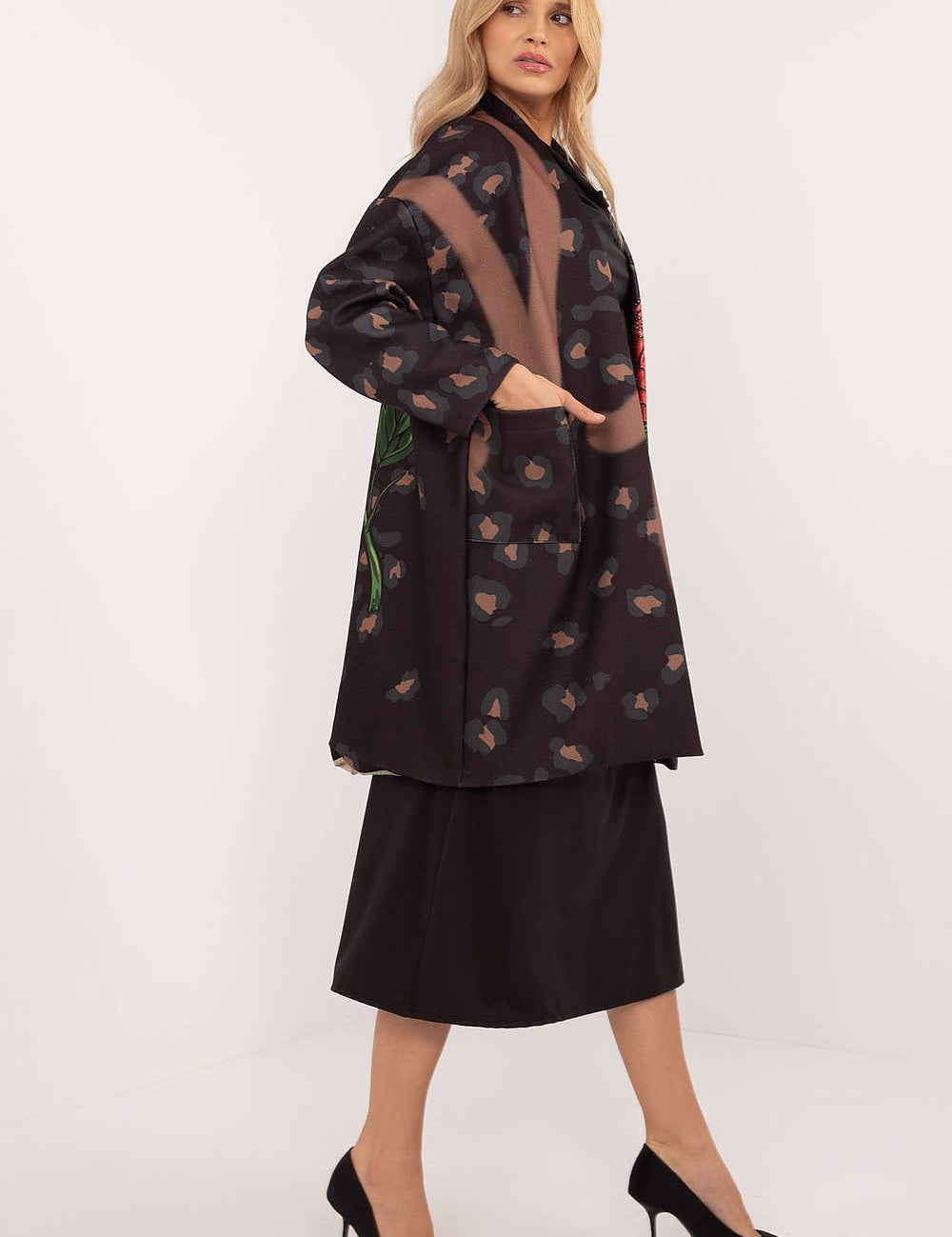 Woman wearing Florénne Rhinestone Rose Coat with stemmed rose print and rhinestone accents, ideal for stylish transitional layering.