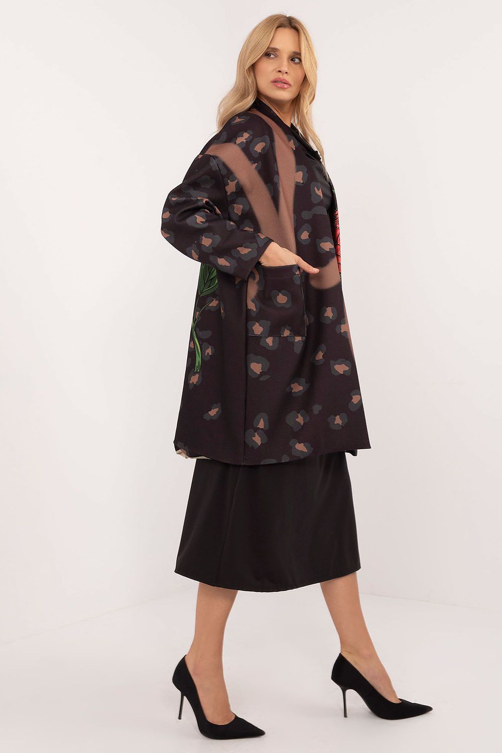 Woman wearing Florénne Rhinestone Rose Coat with stemmed rose print and rhinestone accents, ideal for stylish transitional layering.