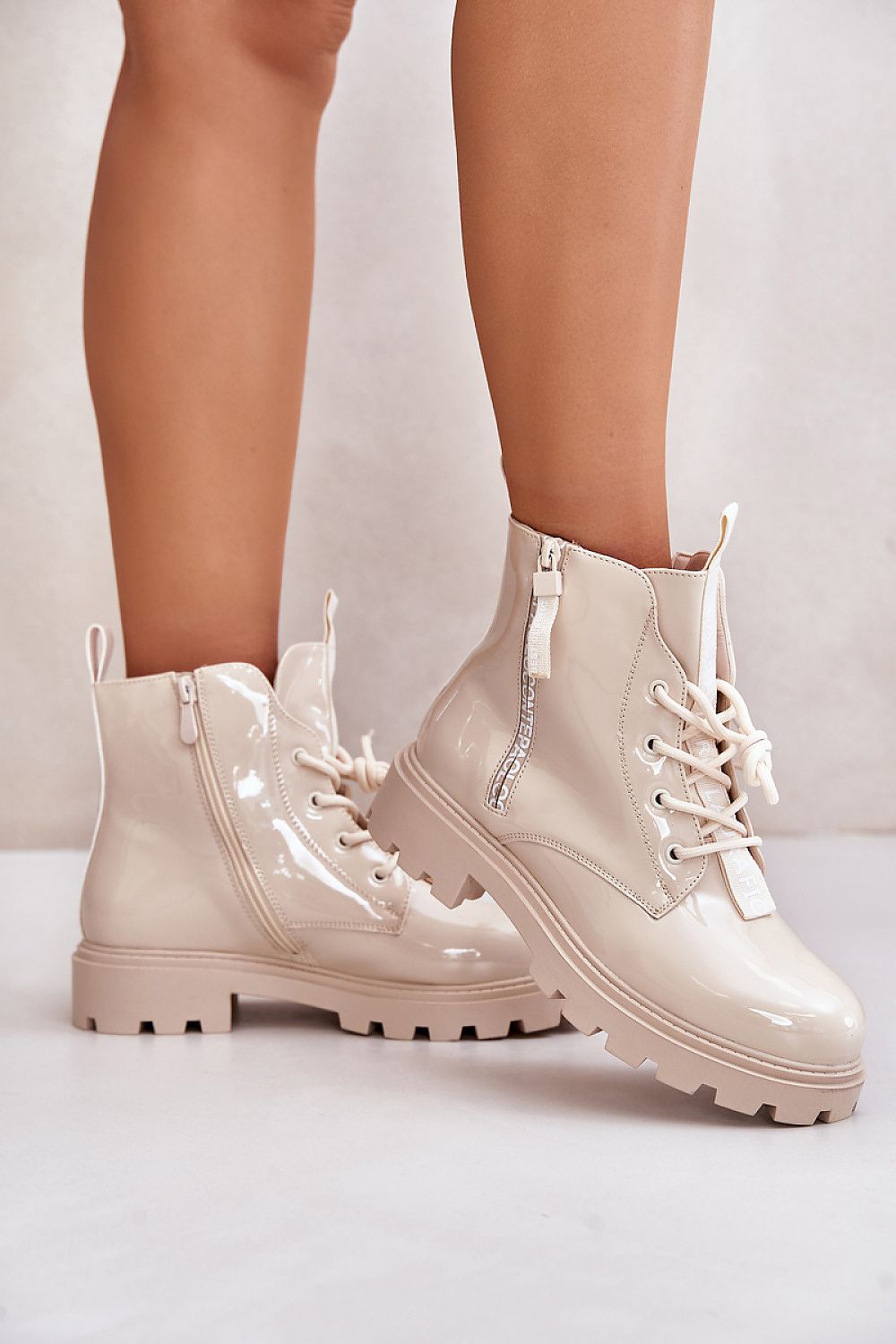Zerenya Textline Insulated Lace-Up Boots in eco leather, featuring side zipper and stylish inscriptions, offering warmth and comfort.