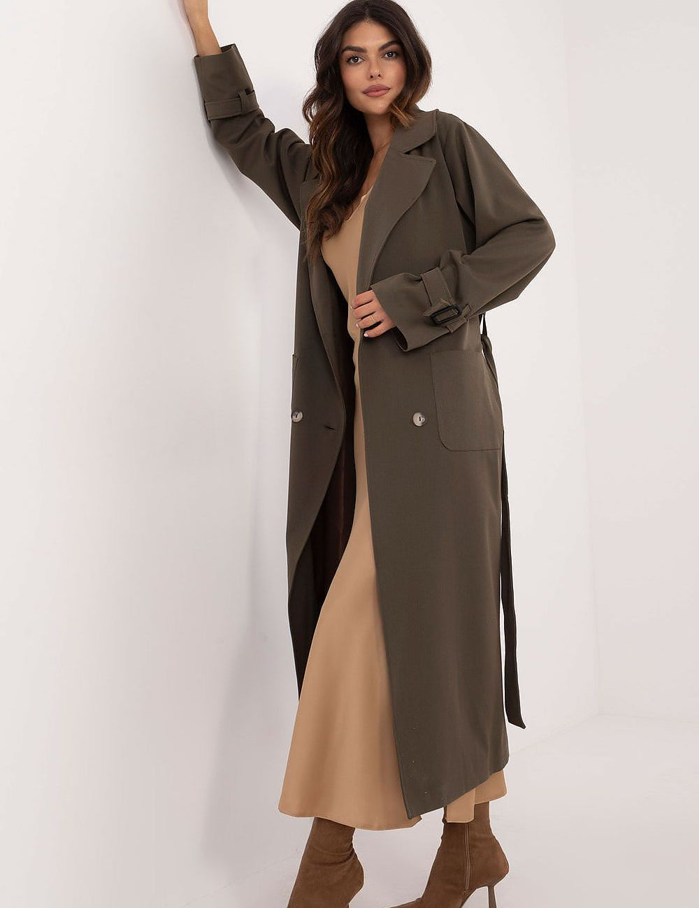Woman wearing Auremere Double-Breasted Trench Coat in olive, exuding timeless elegance and versatility for multiple seasons.