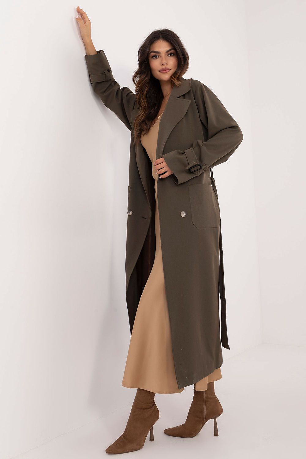 Woman wearing Auremere Double-Breasted Trench Coat in olive, exuding timeless elegance and versatility for multiple seasons.
