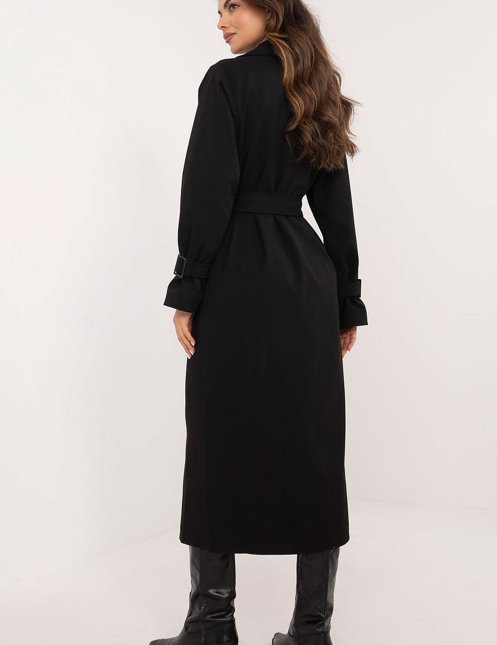 Back view of a woman in a black Auremere Double-Breasted Trench Coat, highlighting its elegant calf-length silhouette and stylish fit.