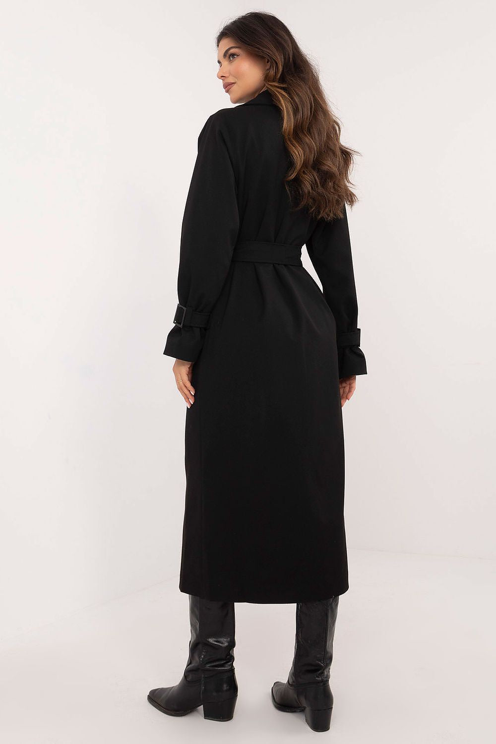 Back view of a woman in a black Auremere Double-Breasted Trench Coat, highlighting its elegant calf-length silhouette and stylish fit.