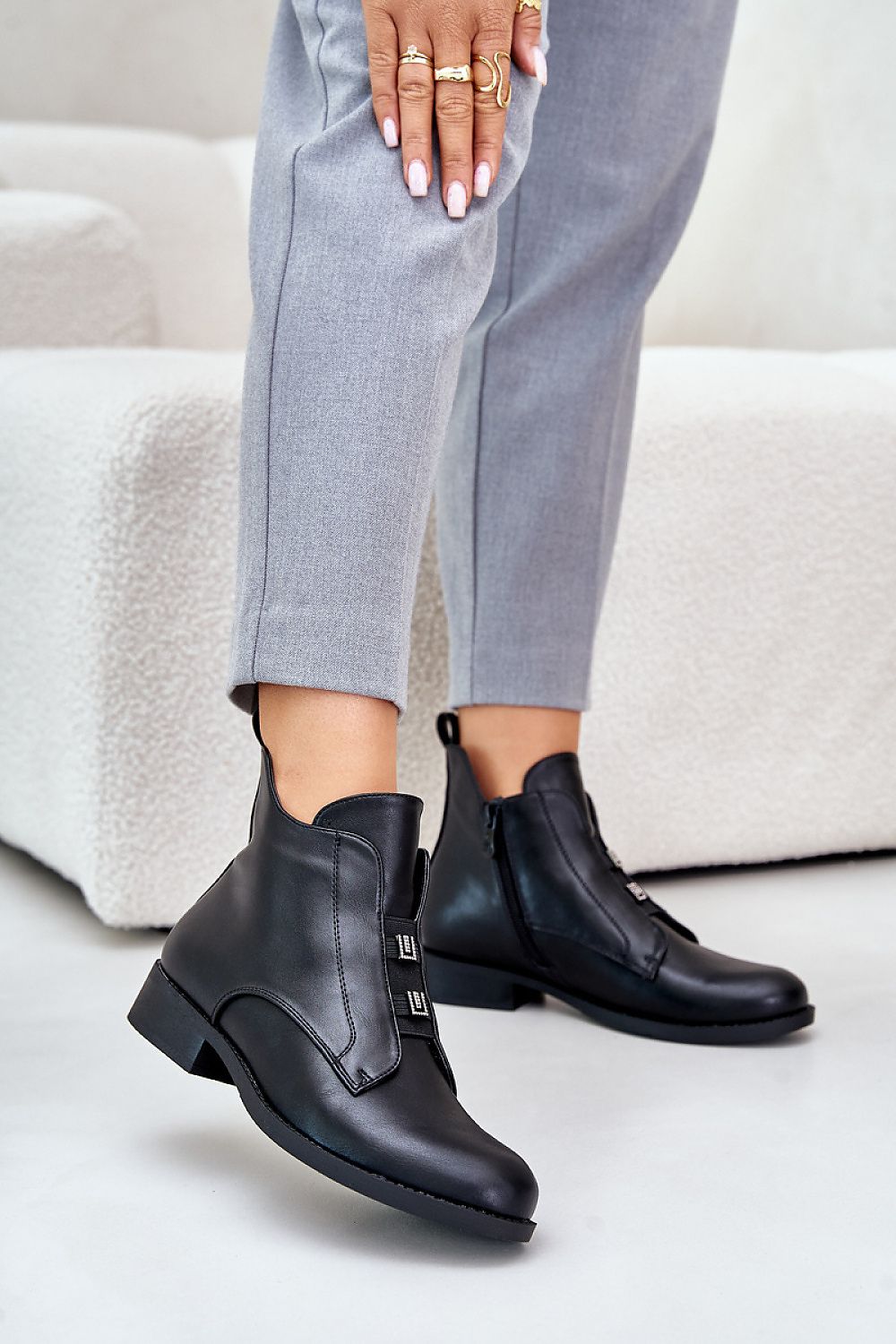 Woman wearing Dovarya Flat Eco Leather Boots with fleece lining, decorative accents, side zipper, ideal for cold weather style.