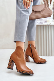 Natural leather ankle boots with almond-shaped toe and cutout upper, featuring high stiletto heel and side zipper on white background.