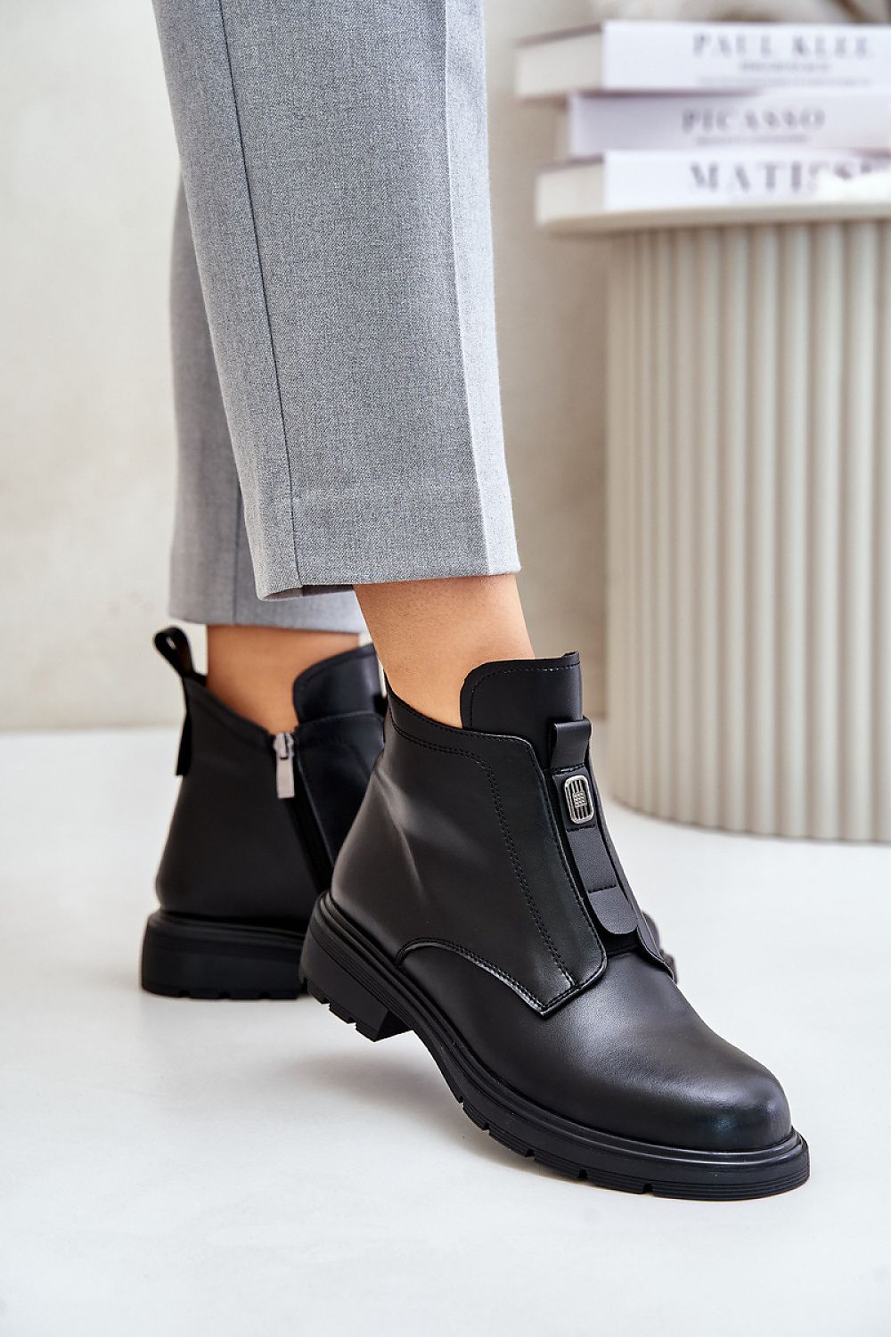 Model wearing Orlavia Flat Leather Winter Boots with side zipper and subtle decorative detail, showcasing comfort and style.
